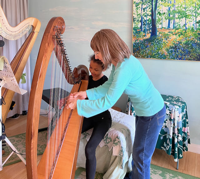 Stephanie Bennett teaches harp to actress Adriana Murigu
