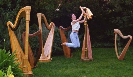 stephanie flying in a forest of harps